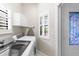 Bright laundry room features modern machines, storage and natural light, offering a functional and organized space at 129 Preserve Pl # D, Nokomis, FL 34275