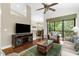 Bright living room with vaulted ceilings, hardwood floors, and views of the private balcony at 129 Preserve Pl # D, Nokomis, FL 34275