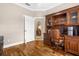 Office featuring hardwood floors, an executive desk, and built-in shelving, creating a productive workspace at 129 Preserve Pl # D, Nokomis, FL 34275