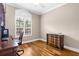 A well-lit office space features hardwood floors, large windows, and ample storage with a classic desk at 129 Preserve Pl # D, Nokomis, FL 34275