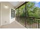 A private screened patio offers serene views of the surrounding lush landscape at 129 Preserve Pl # D, Nokomis, FL 34275