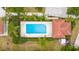 The community pool with lounge chairs is nestled among mature landscaping and palm trees at 129 Preserve Pl # D, Nokomis, FL 34275