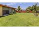 Expansive backyard featuring lush green lawn and mature landscaping at 1320 Whispering Ln, Venice, FL 34285
