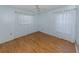 Bright bedroom with laminate flooring and sheer white curtains at 1320 Whispering Ln, Venice, FL 34285