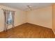 Bedroom featuring laminate flooring and large window with decorative drapes at 1320 Whispering Ln, Venice, FL 34285