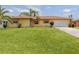 Lovely home with a large lawn and attached two-car garage at 1320 Whispering Ln, Venice, FL 34285