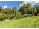 Kayaks stored on rack on grassy hill, next to wooden bridge and scenic waterway with blue skies overhead at 1320 Whispering Ln, Venice, FL 34285