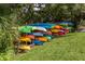Outdoor kayak storage rack with colorful kayaks in a natural setting at 1320 Whispering Ln, Venice, FL 34285