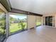 Covered lanai with tiled flooring and screened-in view of the backyard at 1320 Whispering Ln, Venice, FL 34285