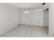 Living room featuring tiled floor and simple chandelier at 1320 Whispering Ln, Venice, FL 34285