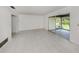 Spacious living room featuring tiled floors and sliding glass doors to the patio at 1320 Whispering Ln, Venice, FL 34285