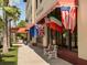 Exterior view of a Venice mall with decorative international flags under an awning at 1320 Whispering Ln, Venice, FL 34285