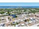 Scenic aerial view of a coastal community with waterways, lush greenery, and a view of the ocean at 13579 Romford Ave, Port Charlotte, FL 33981