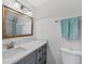 Clean bathroom featuring a vanity with a solid surface top and ample storage space at 13579 Romford Ave, Port Charlotte, FL 33981
