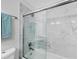 Modern bathroom with a glass shower featuring elegant marble-style tiling and a sleek shower head at 13579 Romford Ave, Port Charlotte, FL 33981