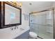 Modern bathroom featuring a sleek vanity, glass-enclosed shower, and contemporary fixtures for a luxurious feel at 13579 Romford Ave, Port Charlotte, FL 33981