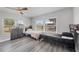 Bright bedroom with modern grey flooring, twin beds, two large windows, and plenty of closet space at 13579 Romford Ave, Port Charlotte, FL 33981
