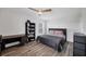 Comfortable bedroom featuring a cozy bed, a desk, and wood-look tile floors, providing a relaxing space at 13579 Romford Ave, Port Charlotte, FL 33981