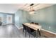 Elegant dining room with modern lighting and a sleek dining table, ideal for Gathering meals at 13579 Romford Ave, Port Charlotte, FL 33981