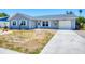 Charming single-story home with a well-maintained yard, attached garage, and classic curb appeal at 13579 Romford Ave, Port Charlotte, FL 33981