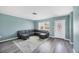 Inviting living room featuring a comfortable gray sectional, creating a cozy and welcoming atmosphere at 13579 Romford Ave, Port Charlotte, FL 33981