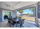 Screened patio with table and chairs perfect for enjoying outdoor dining and relaxing in comfort at 13579 Romford Ave, Port Charlotte, FL 33981