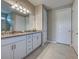 Modern bathroom featuring a double vanity with granite countertops and stylish fixtures, alongside tile flooring at 13731 Vadini St, Venice, FL 34293