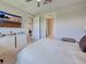 Spacious bedroom featuring a sleek TV, neutral decor, and easy access to other parts of the house at 13731 Vadini St, Venice, FL 34293