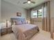 Bedroom featuring a queen bed, neutral walls, carpet, a ceiling fan and a view of the neighborhood through the window at 13731 Vadini St, Venice, FL 34293