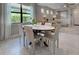 Well-lit dining area with modern furniture and view of the living space and outdoor scenery at 13731 Vadini St, Venice, FL 34293