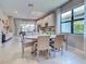 Open dining area with modern chandelier, large windows, and connection to the kitchen at 13731 Vadini St, Venice, FL 34293