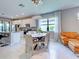 Bright dining area featuring modern lighting, white cabinets, and stainless steel appliances at 13731 Vadini St, Venice, FL 34293