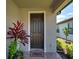 Welcoming front door with a stylish doormat and beautiful potted plant decorations at 13731 Vadini St, Venice, FL 34293