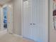 Hallway featuring white doors, neutral walls, and a view of a bedroom in the distance at 13731 Vadini St, Venice, FL 34293