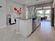 Kitchen island with granite countertops, stainless steel dishwasher, and seating overlooking the patio at 13731 Vadini St, Venice, FL 34293