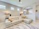 Cozy living room with modern sectional, neutral walls, and abundant natural light at 13731 Vadini St, Venice, FL 34293