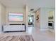 Bright living room featuring a modern entertainment center and tile flooring at 13731 Vadini St, Venice, FL 34293