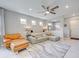 Open concept living area with stylish seating and a modern ceiling fan at 13731 Vadini St, Venice, FL 34293