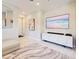 Elegant living room with neutral walls, tile flooring, and modern artwork at 13731 Vadini St, Venice, FL 34293