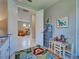 Bright playroom showcasing a colorful rug, a small table with chairs and playful artwork at 13731 Vadini St, Venice, FL 34293