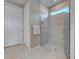 Modern bathroom featuring a frameless glass shower, neutral tile, and a sleek design with natural light at 13731 Vadini St, Venice, FL 34293