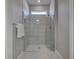 Modern bathroom featuring a frameless glass shower, sleek design with natural light, and neutral tile at 13731 Vadini St, Venice, FL 34293