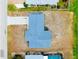 Aerial view showcasing the home's layout on a spacious lot within a serene neighborhood setting at 144 Rotonda Cir, Rotonda West, FL 33947