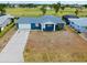 Aerial view showcasing the home's prime location near the golf course and serene surroundings at 144 Rotonda Cir, Rotonda West, FL 33947