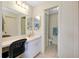 Bright bathroom featuring a vanity with a makeup desk and an adjacent toilet at 144 Rotonda Cir, Rotonda West, FL 33947