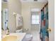 Bathroom view of a shower, toilet, and vanity leading into an adjoining bedroom at 144 Rotonda Cir, Rotonda West, FL 33947