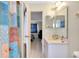 Bathroom view of a shower with patterned curtains, a toilet, and a sink area at 144 Rotonda Cir, Rotonda West, FL 33947