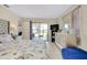 Well-lit bedroom with light-colored walls, tiled floors, and an ensuite bathroom at 144 Rotonda Cir, Rotonda West, FL 33947