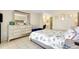 Well-lit bedroom with light-colored walls, tiled floors, and an ensuite bathroom at 144 Rotonda Cir, Rotonda West, FL 33947