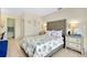 Well-lit bedroom with light-colored walls, tiled floors, and an ensuite bathroom at 144 Rotonda Cir, Rotonda West, FL 33947